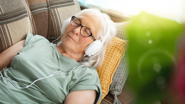 Relaxed older woman wearing headphones