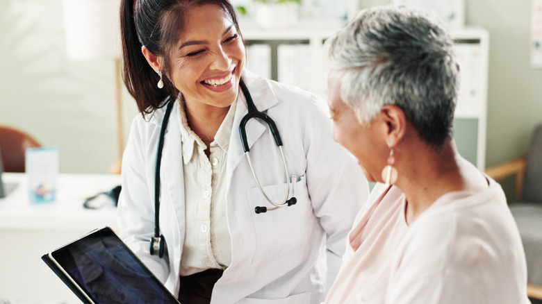 A woman and her doctor talking and smiling