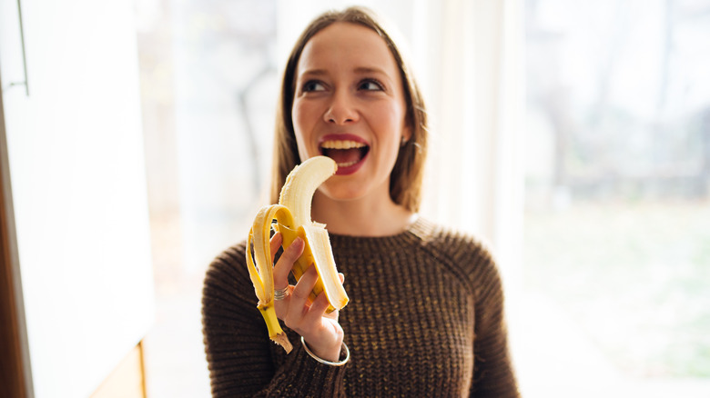 Woman eating banana