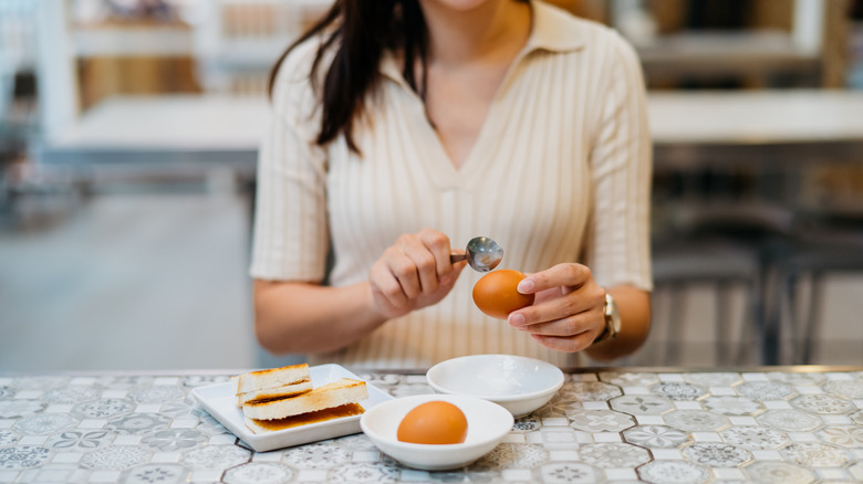Woman eating eggs