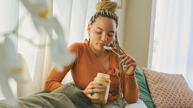 woman eating peanut butter