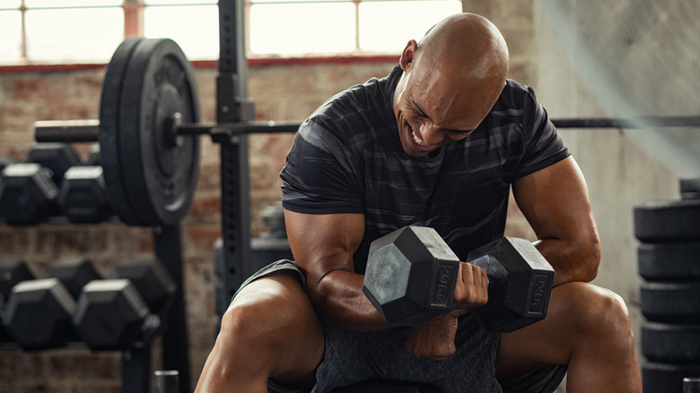 A man lifts weights in the gym