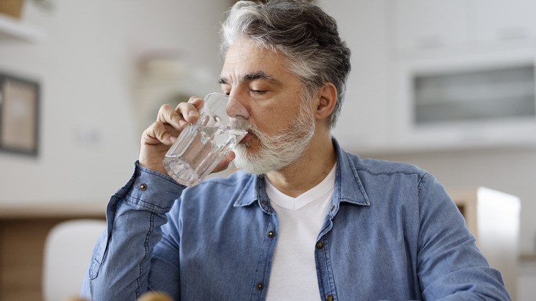 older man drinking water