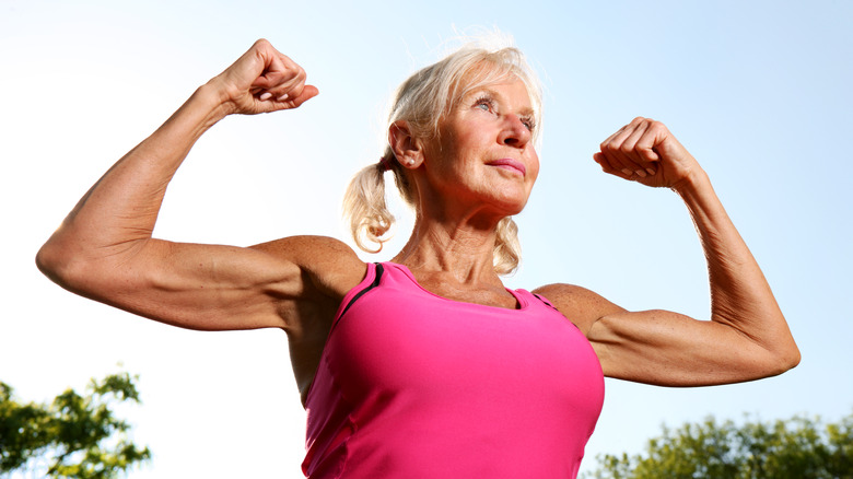 older woman flexing her biceps