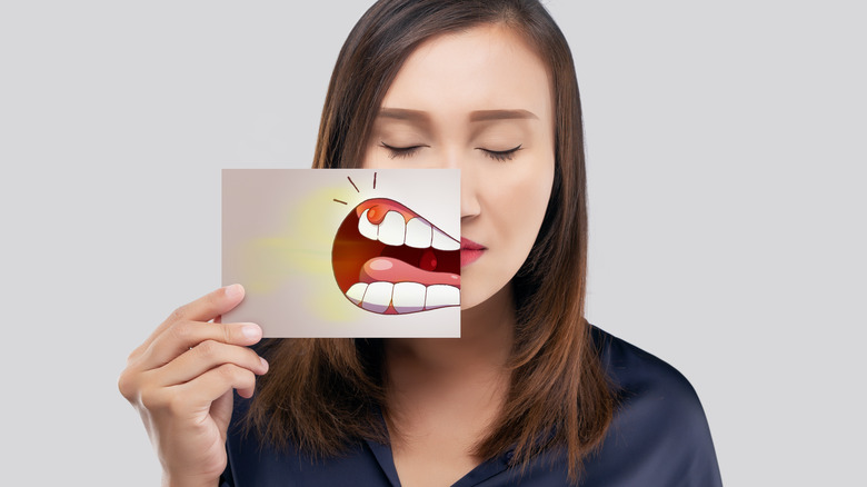 woman holding illustration of mouth