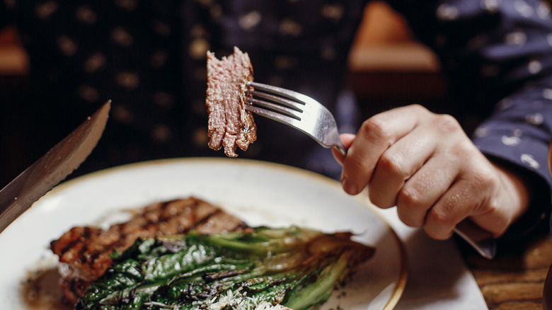 Man eating red meat