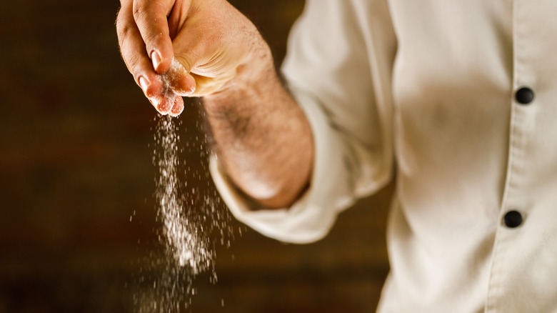 Man sprinkling salt