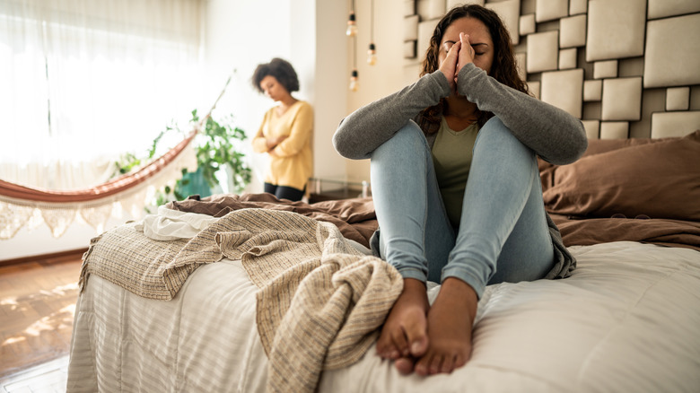 Woman with headache in bed