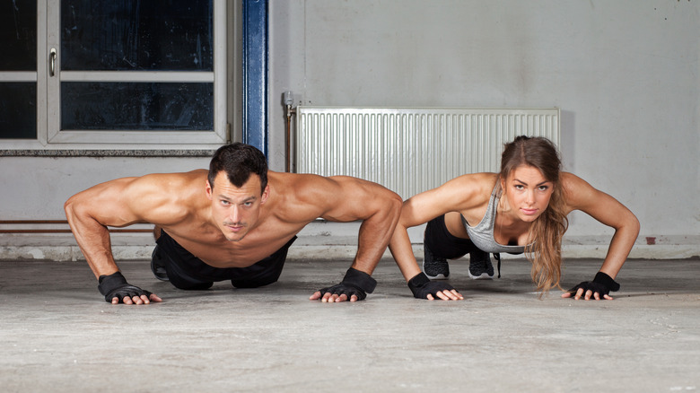 man and woman doing pushups