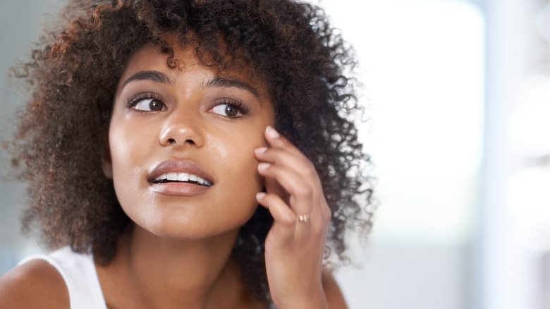 Woman looking at skin