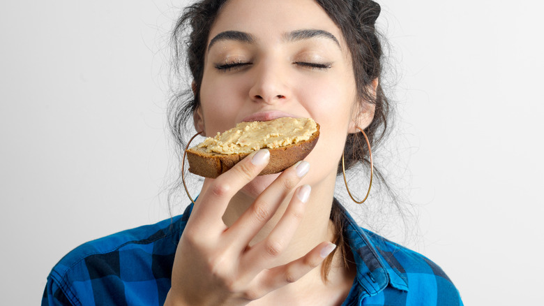 Woman eating peanut butter