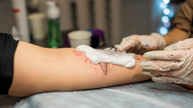 Person cleaning a new tattoo