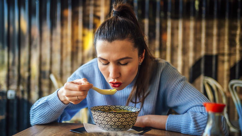 Woman eating hot soup