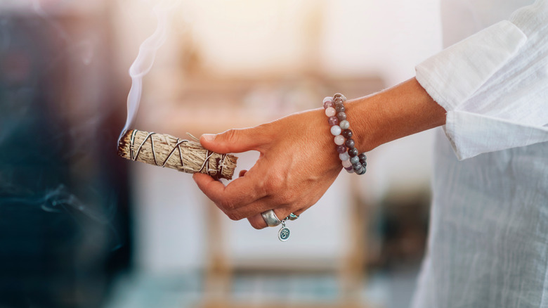 Woman burning sage