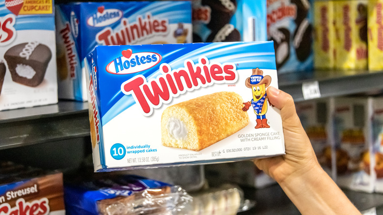 hand taking a box of Twinkies off the grocery shelf