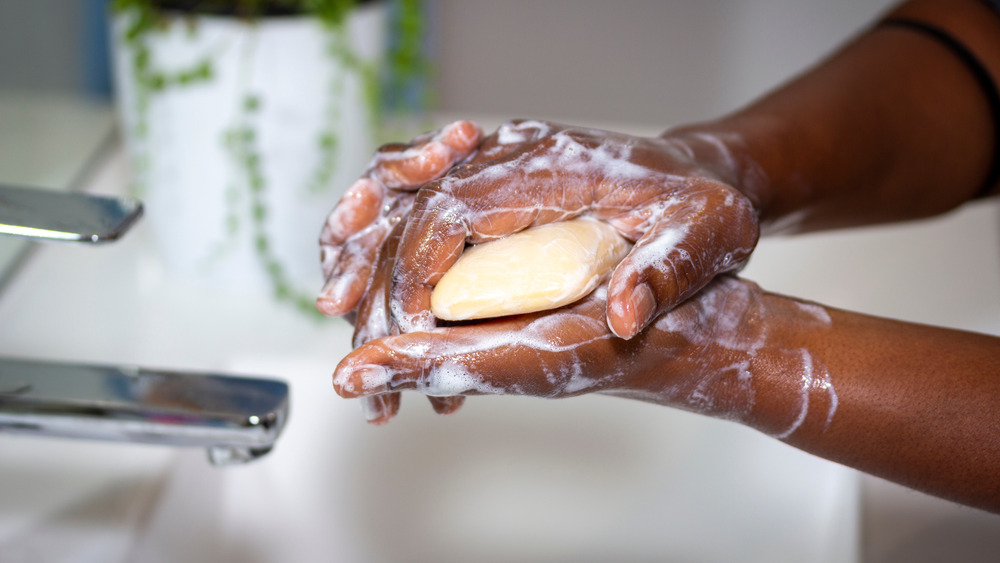 Man washes hands with soap