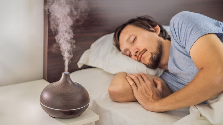 Man in bed and diffuser 