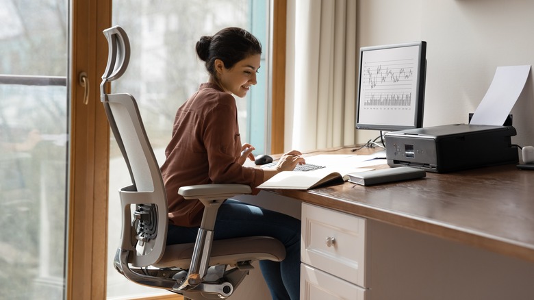 A woman sits at her desk and works