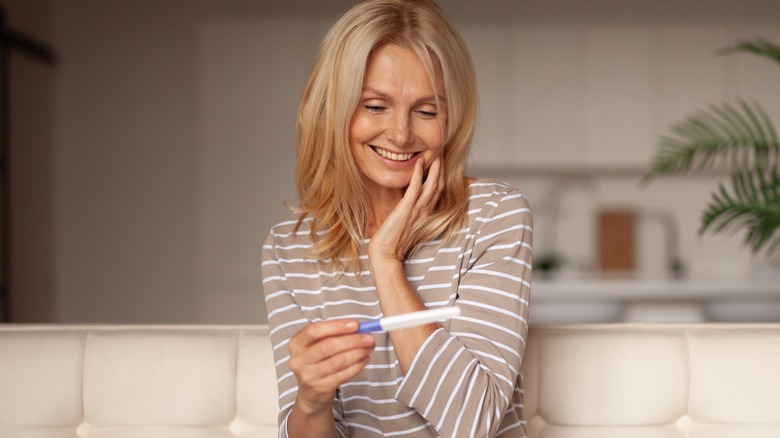 happy woman with pregnancy test