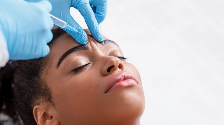 Woman receiving facial dermal filler