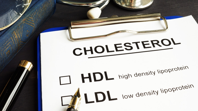 paper with words 'cholesterol, HDL, LDL'