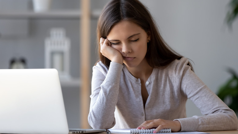 tired woman sitting at desk