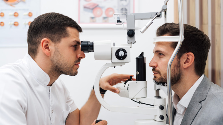 eye doctor examining man's corneas