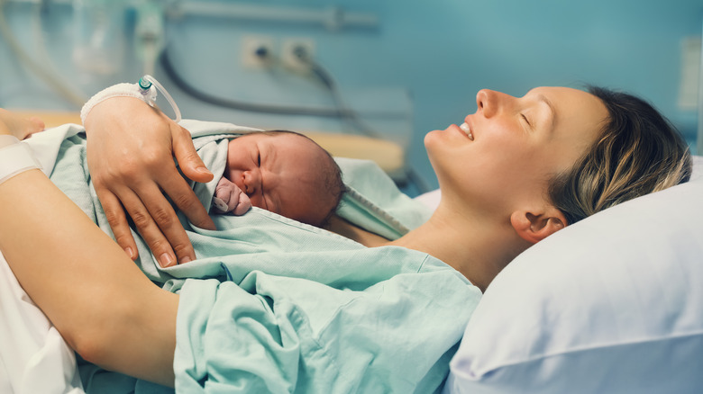 mom holding her newborn after childbirth