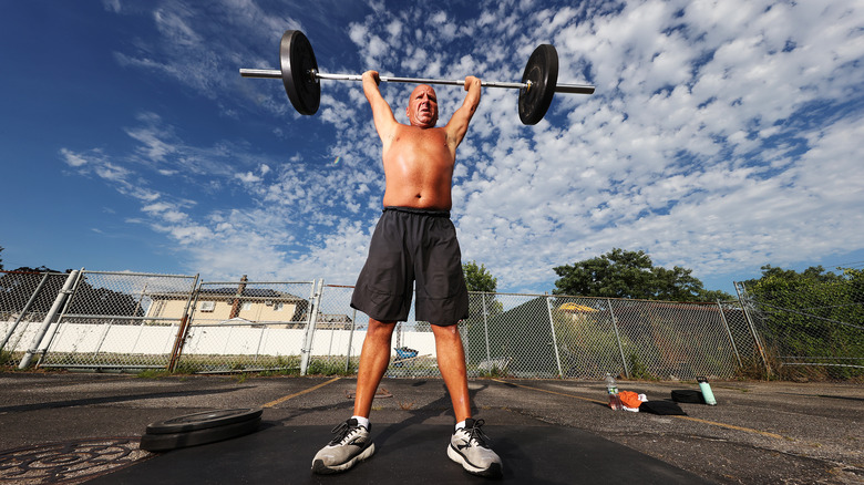 man lifting barbell