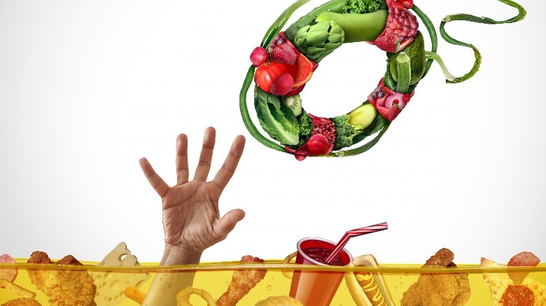 Artist concept of drowning in unhealthy food