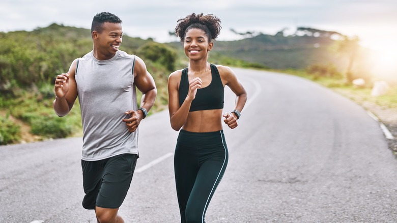 A man and a woman exercise together