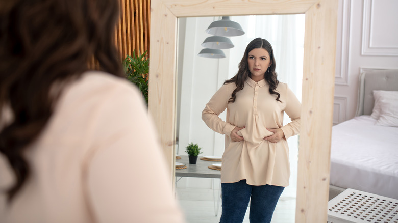 woman looking in mirror