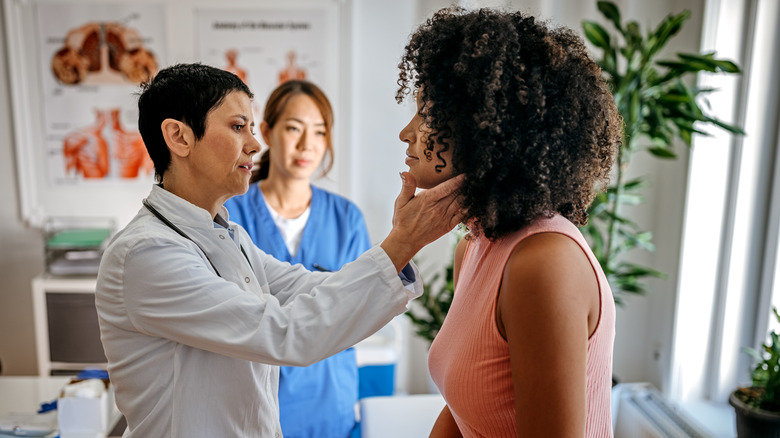 Doctor examining patient's throat