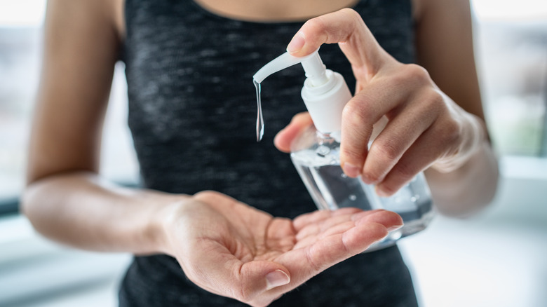 Woman pumping hand sanitizer