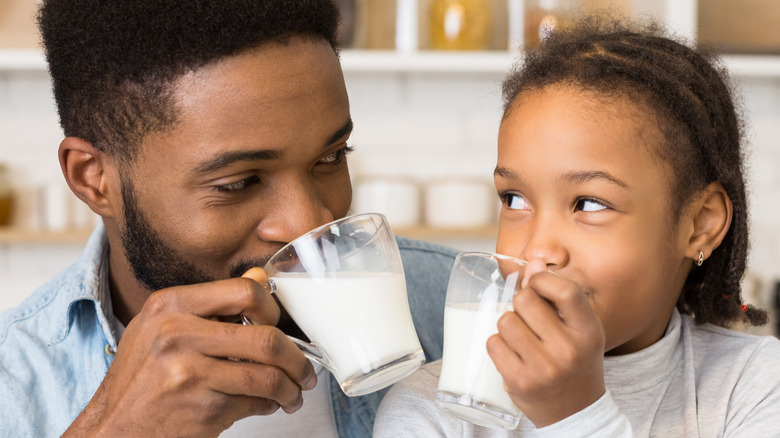 Father and child drinking milk