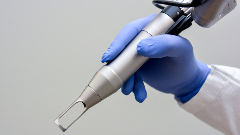 doctor holding skin lightening laser