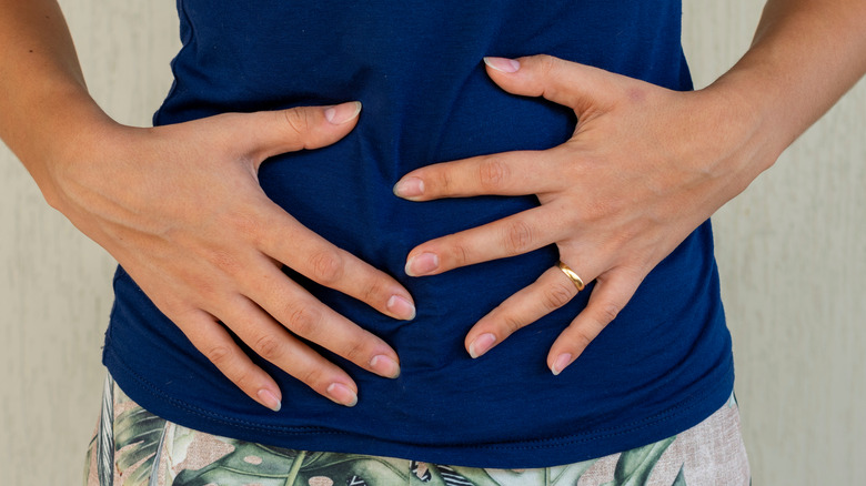 woman holding stomach