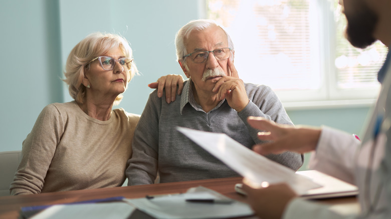 older couple in consultation with doctor