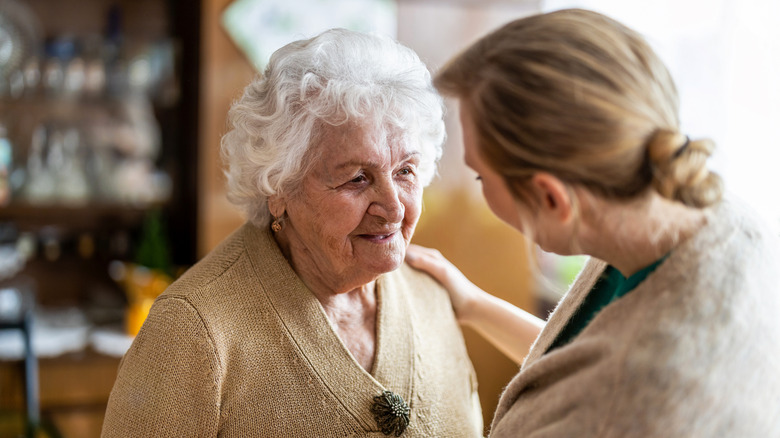 woman talking to senior citizen