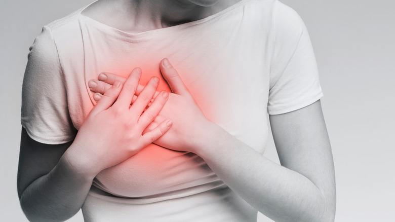 woman holding painful breast
