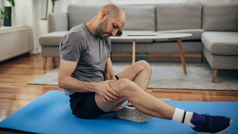 Man looking at his leg