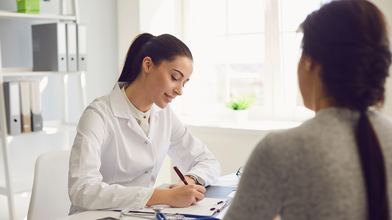 Woman talking to doctor 