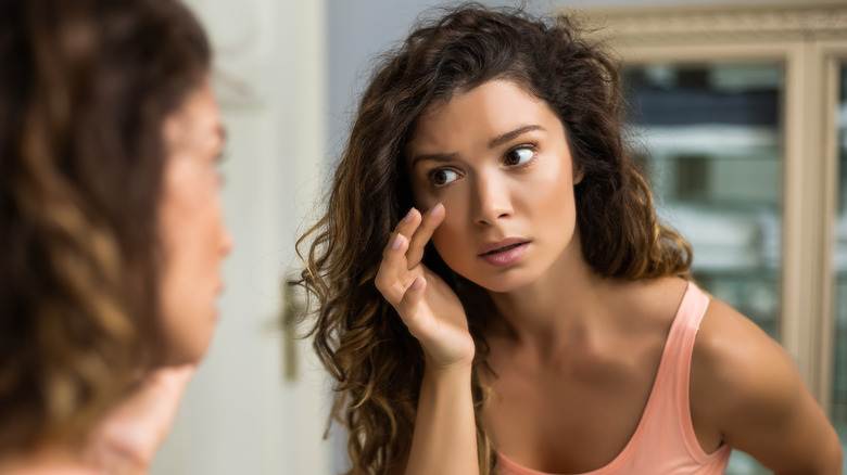 woman looking in mirror