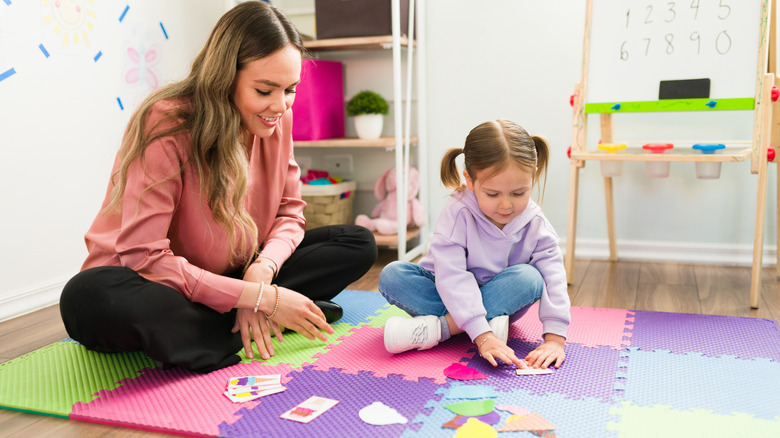 Therapist doing a puzzle with child
