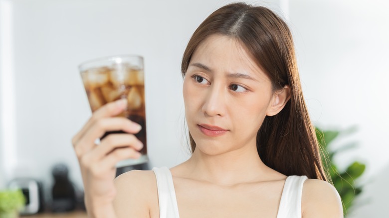 Woman looking at soda