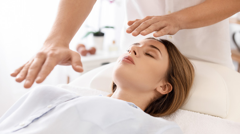 woman receiving reiki treatment