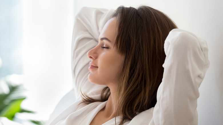 woman with eyes closed breathing deep