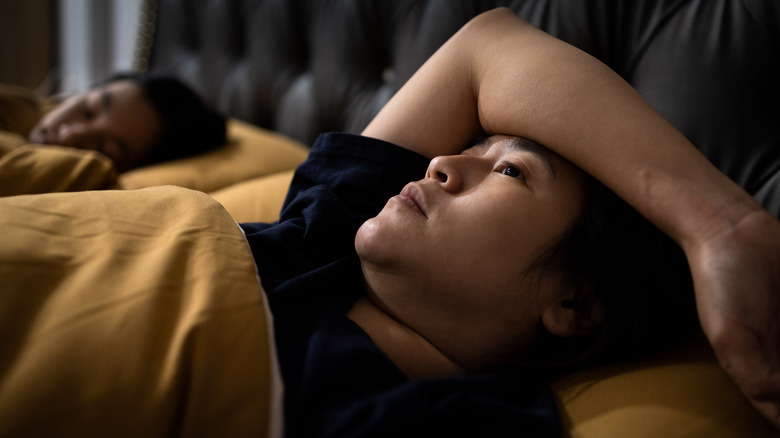 Woman in bed unable to sleep