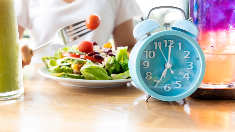 a plate of food with a clock nearby