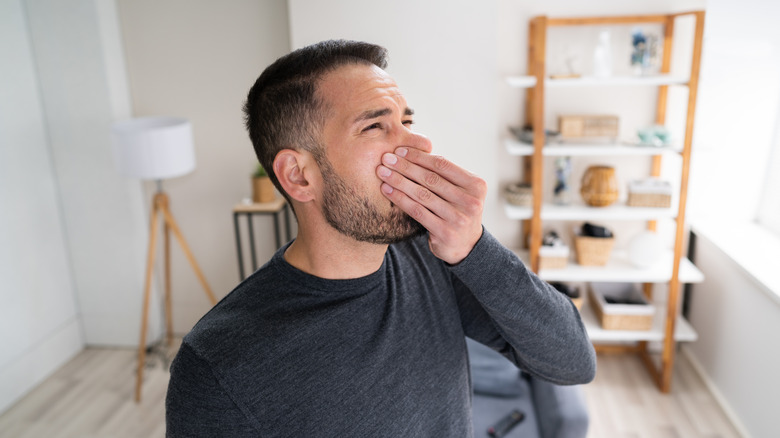 Man reacting to bad smell